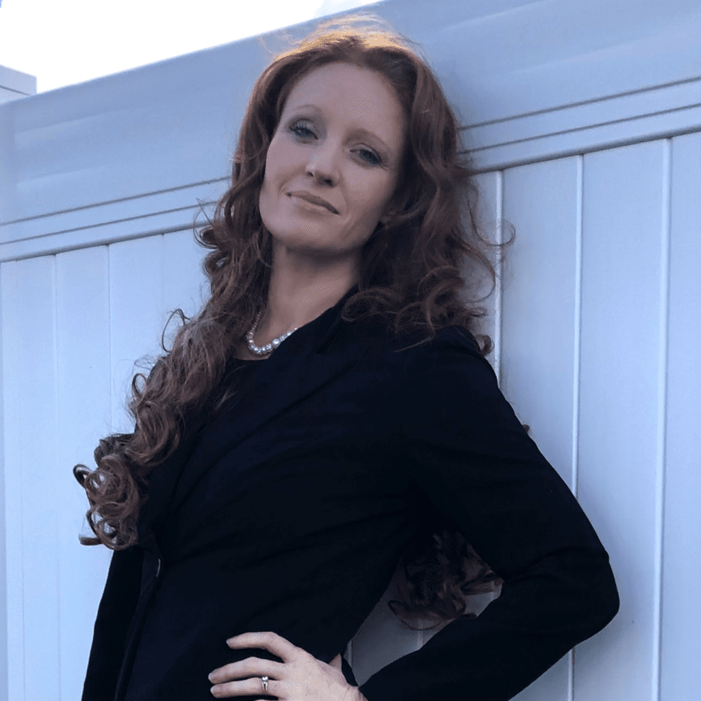 Jennifer Crockett wearing a black suit and pearls