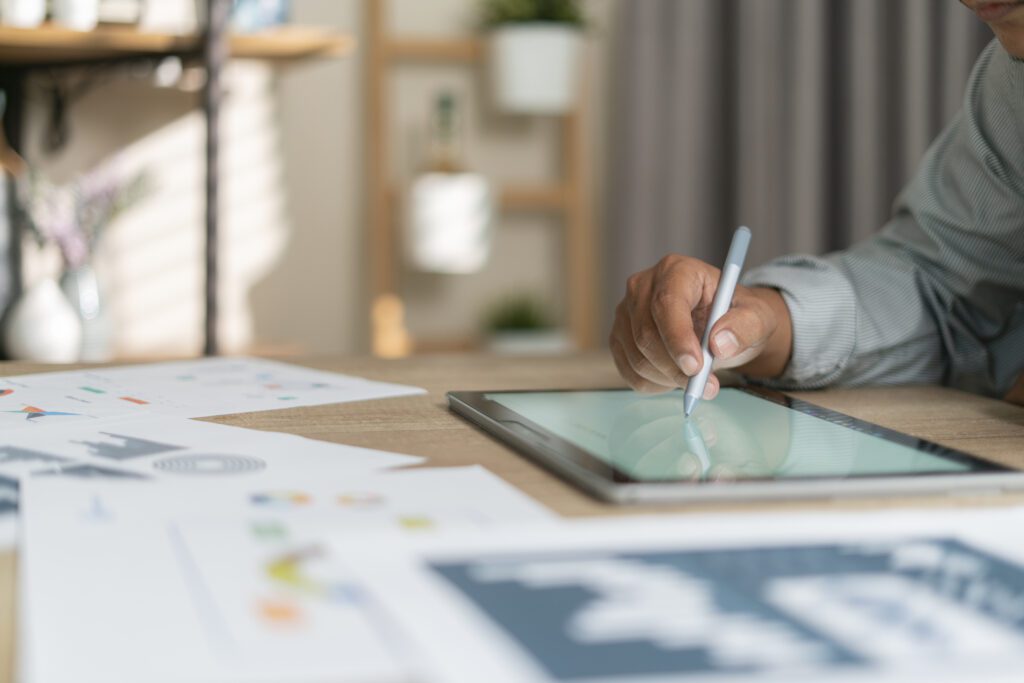 Young man using pen and tablet